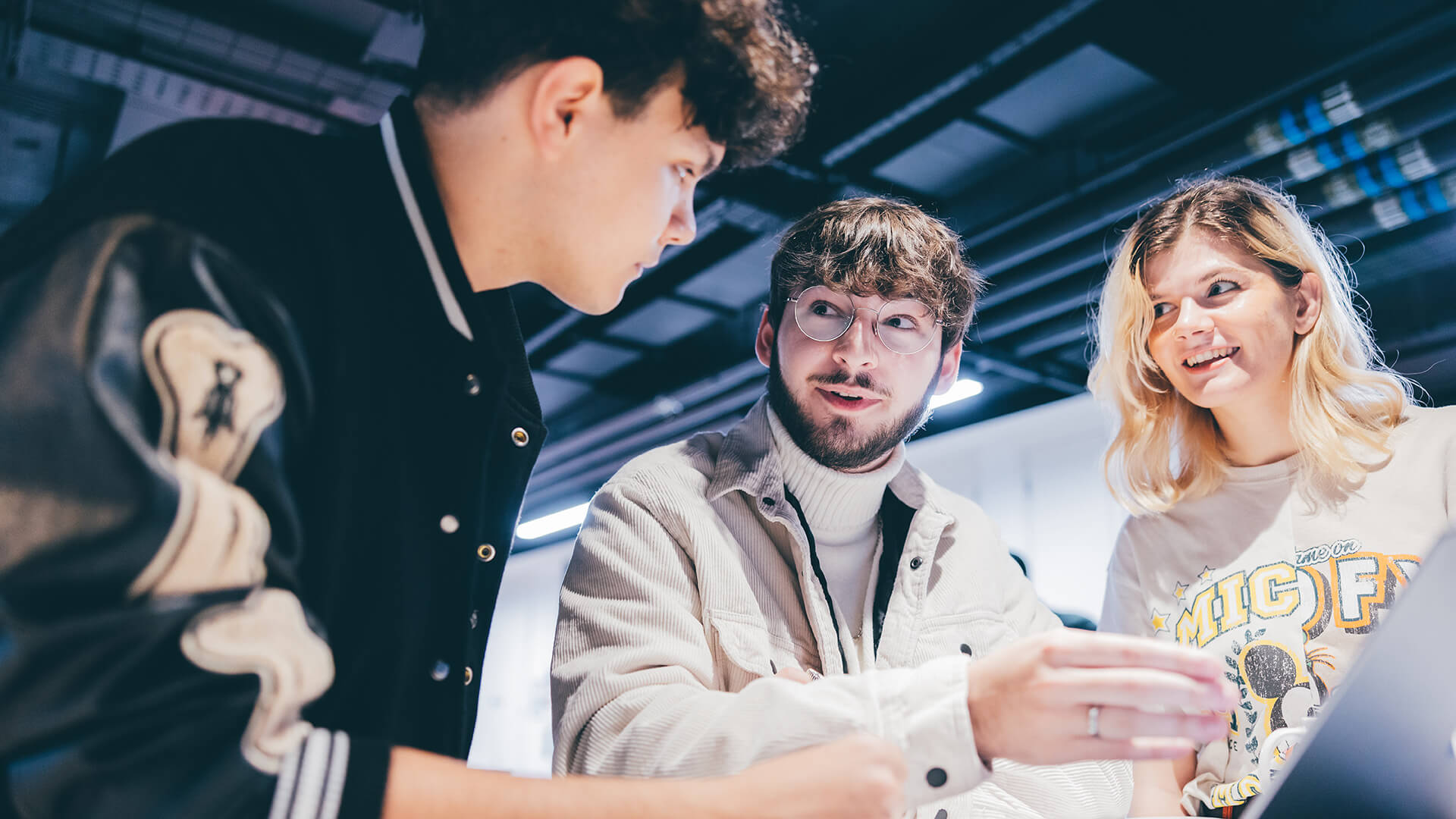 Students talking near laptop